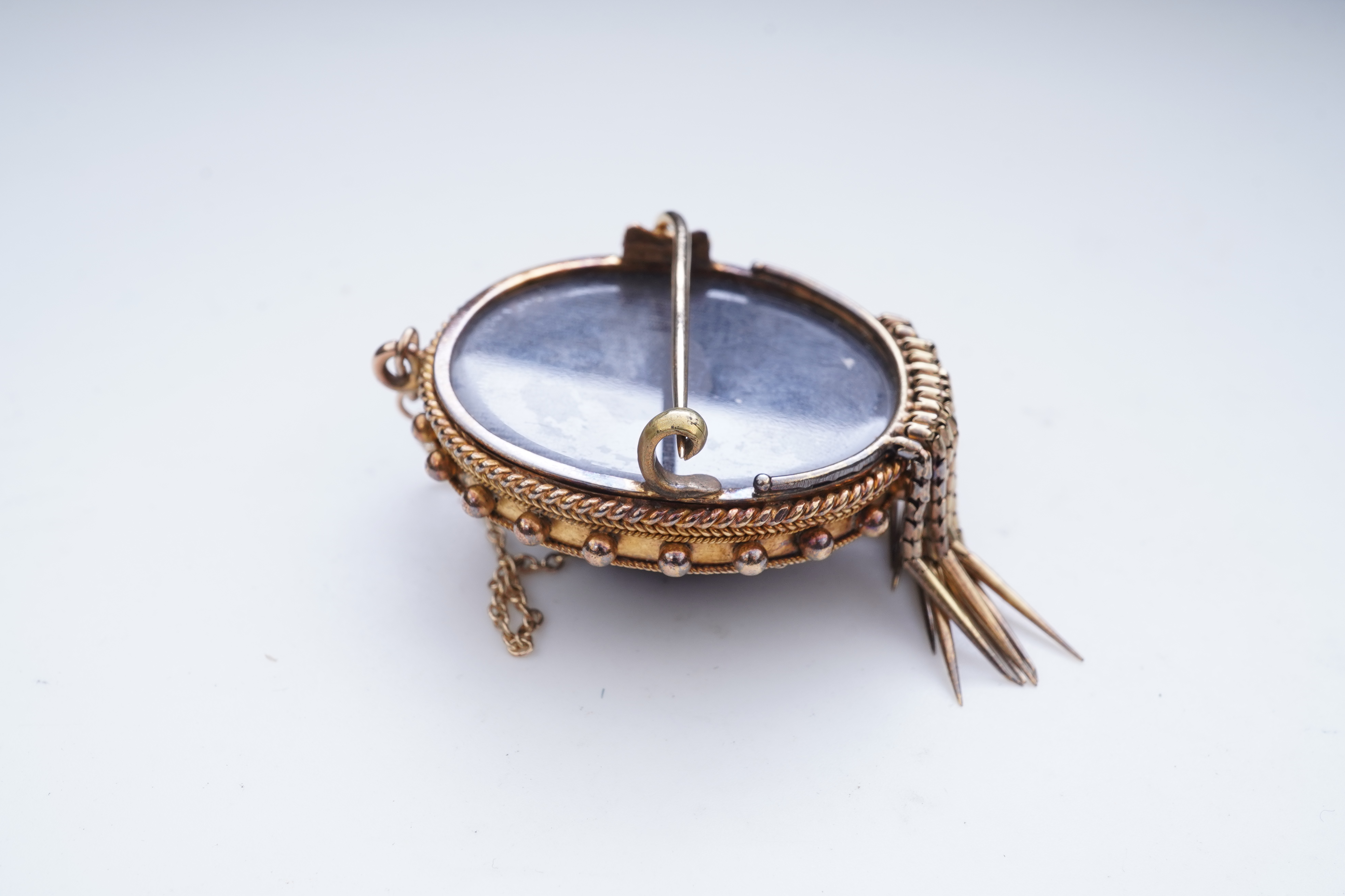 A Victorian garnet and enamel brooch, mid 19th century